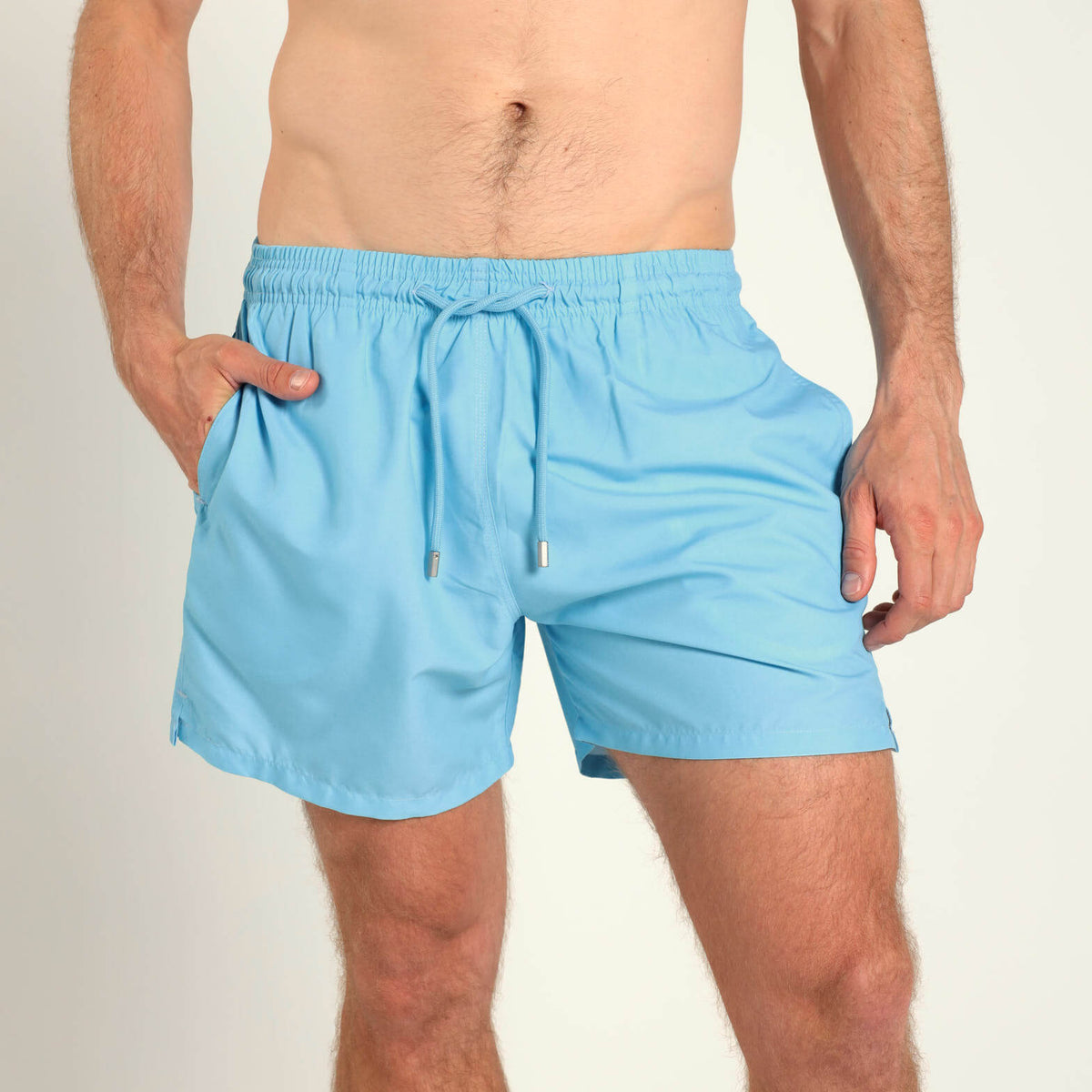 Breazies men’s baby blue swim shorts with an elastic waistband and blue drawstring.