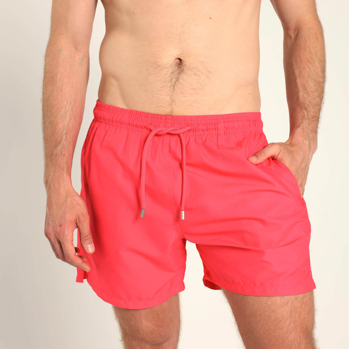 Breazies men’s coral swim shorts with an elastic waistband and coral drawstring.