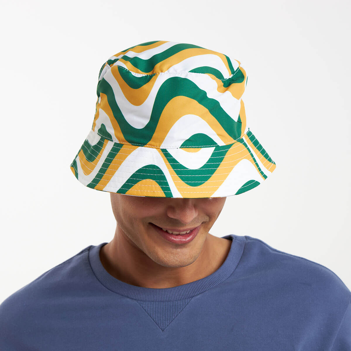 A man wearing a green, gold and white bucket hat.