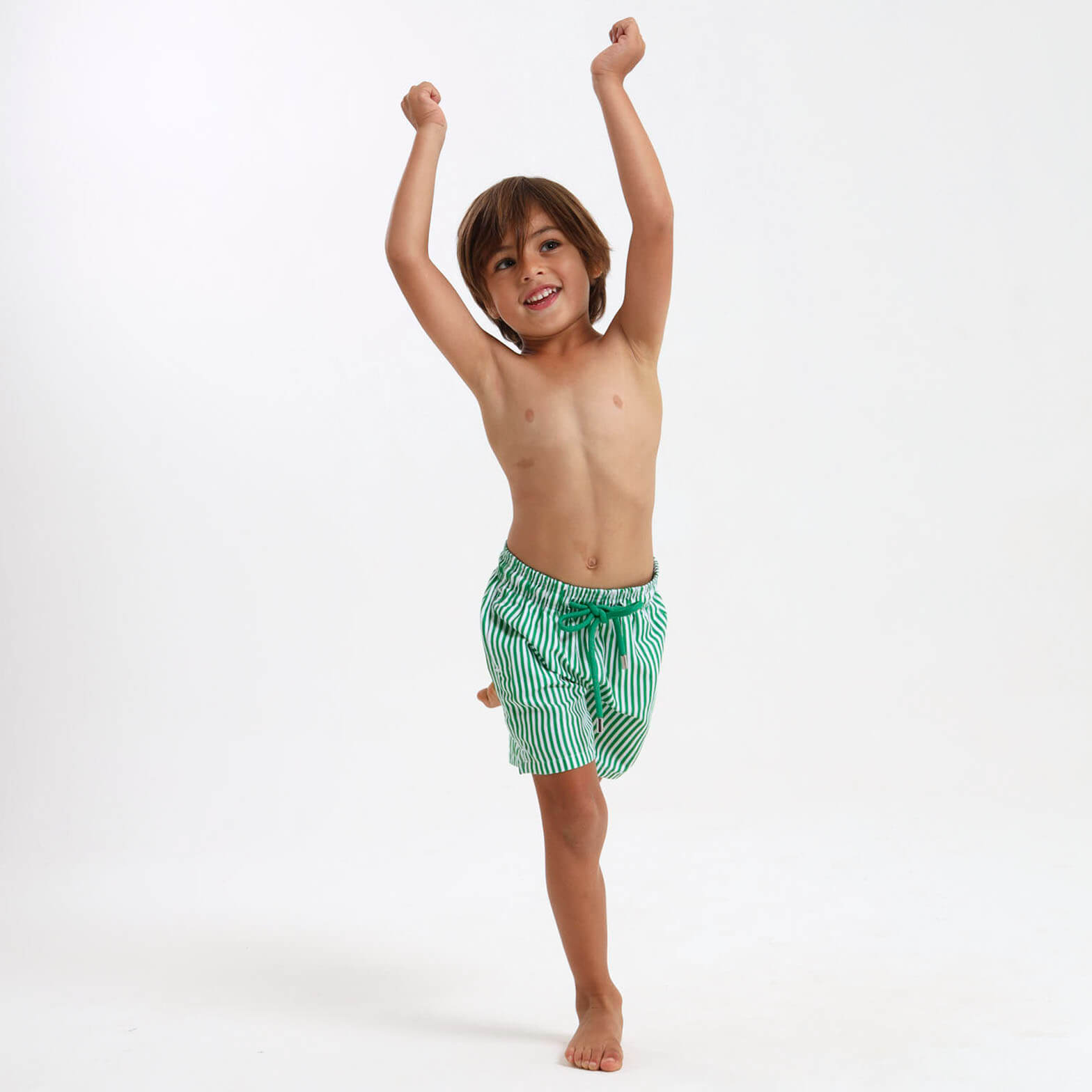 Kid wearing green and white swim shorts