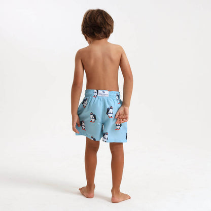 Child wearing a pair of Breazies blue penguin swim shorts.