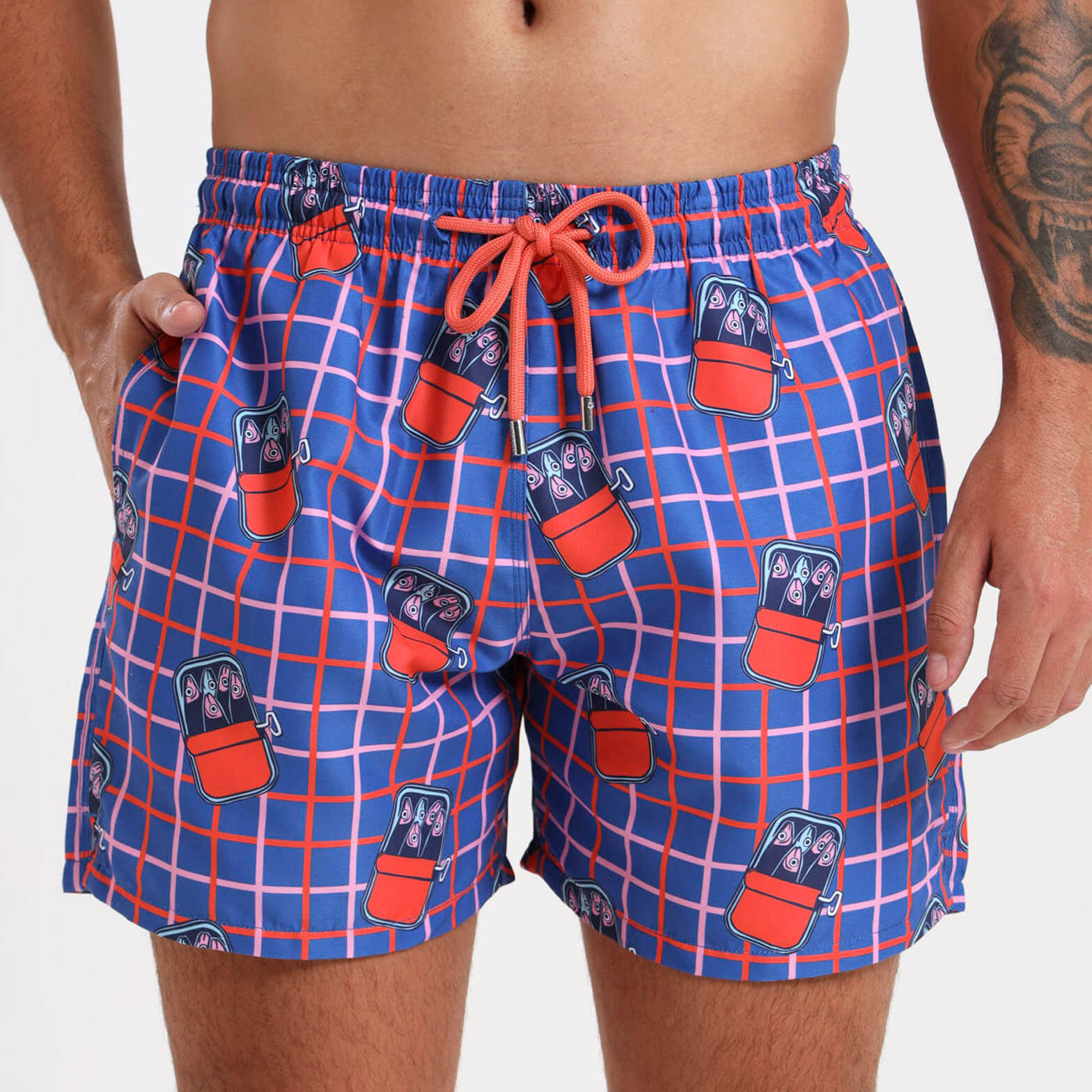 Swim shorts with a quirky meditereanean inspired sardine illustration on a checkered back ground.