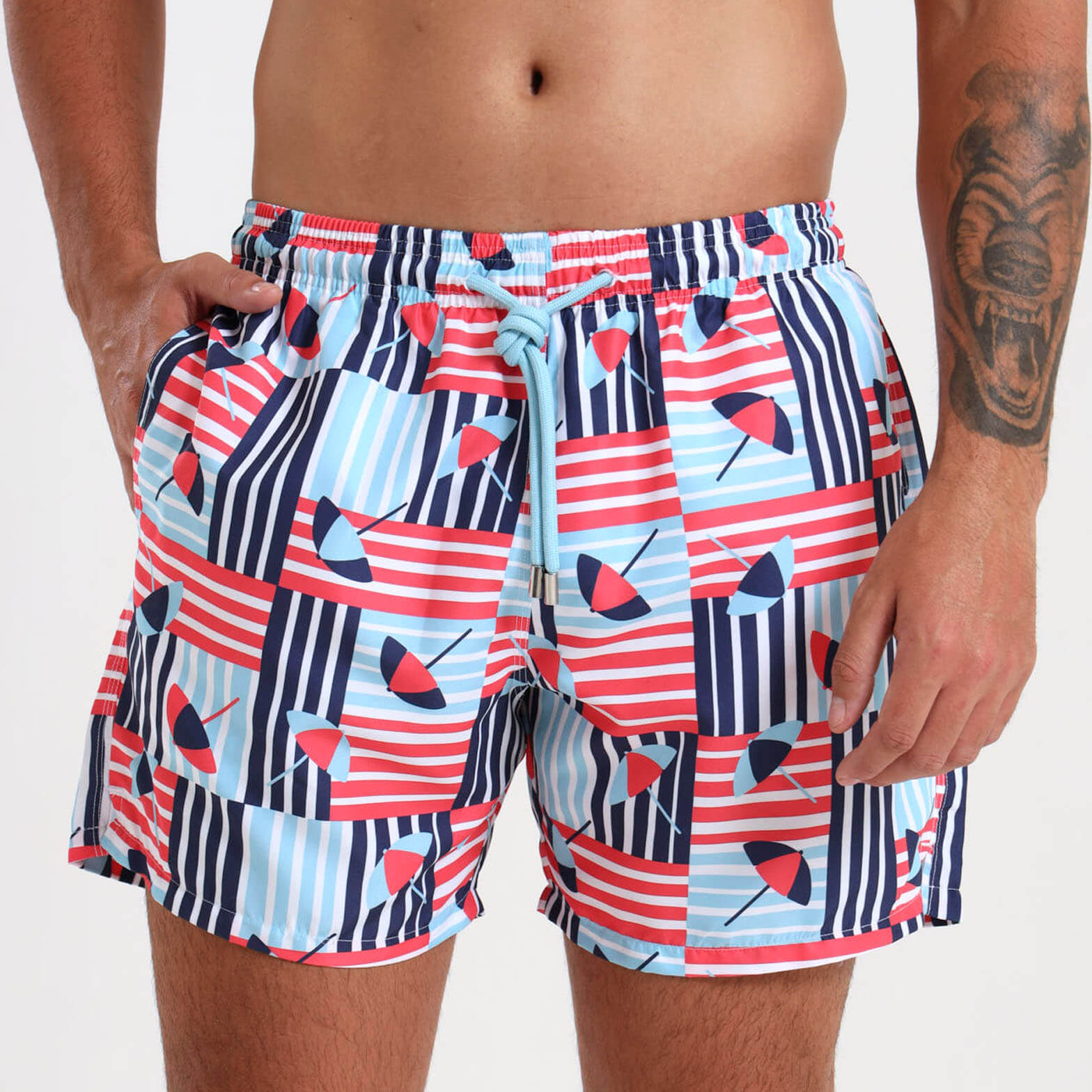 Mens mid length swim shorts with a beach umbrella design