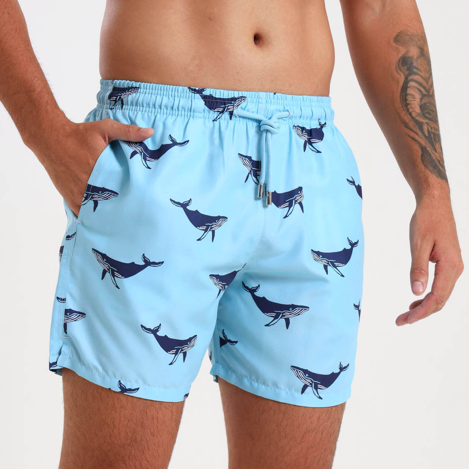 Light blue swim shorts for men with a navy whale design