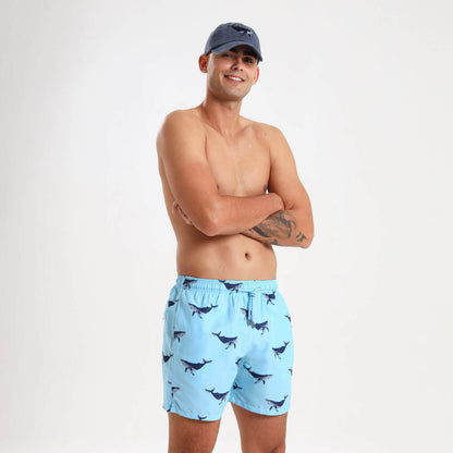 Light blue elasticated swim trunks for men with a whale design on them.