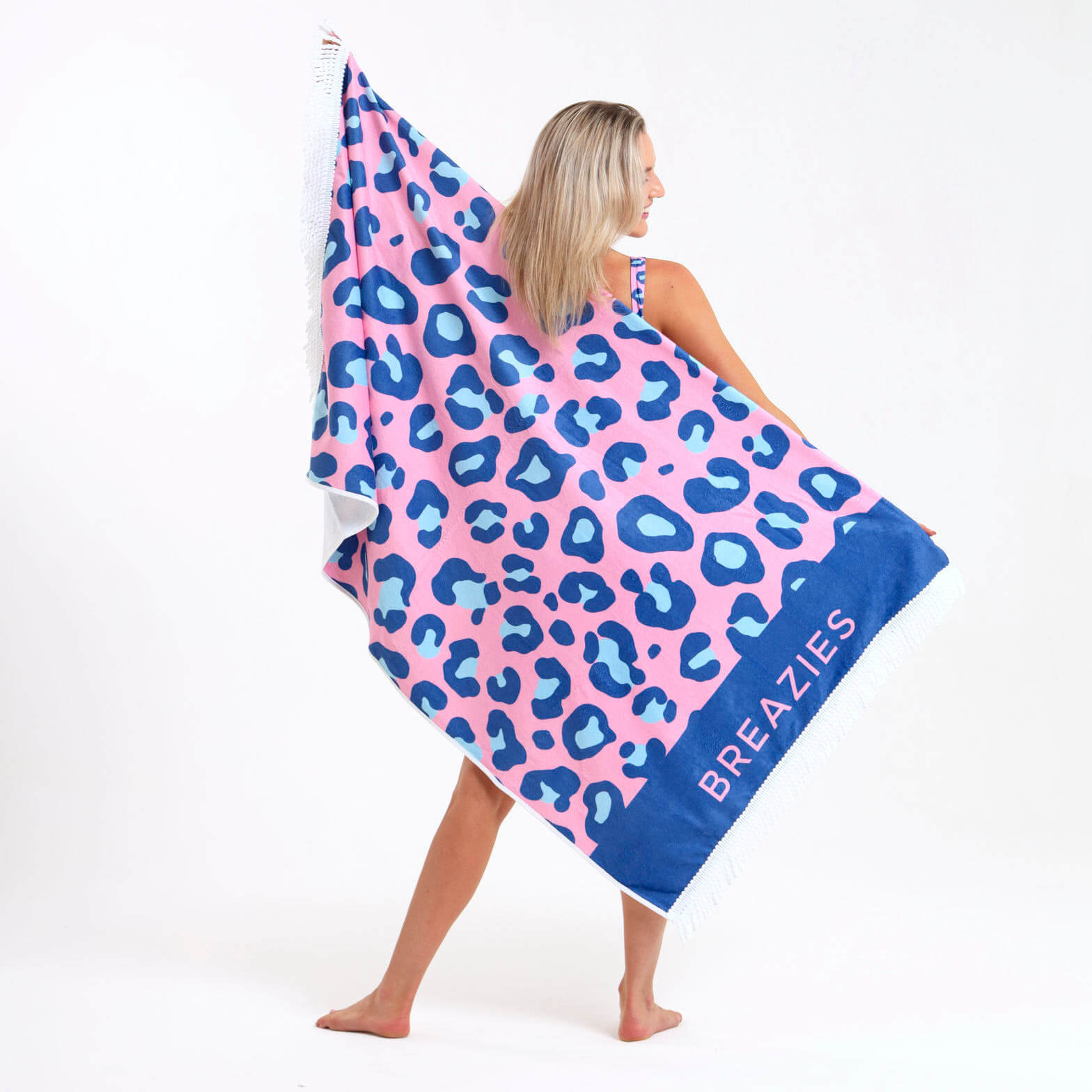Beach towel with a pink and blue leopard print design.