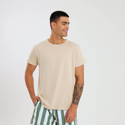 A male model wearing a beige cotton T-shirt with short sleeves and a crew neckline.
