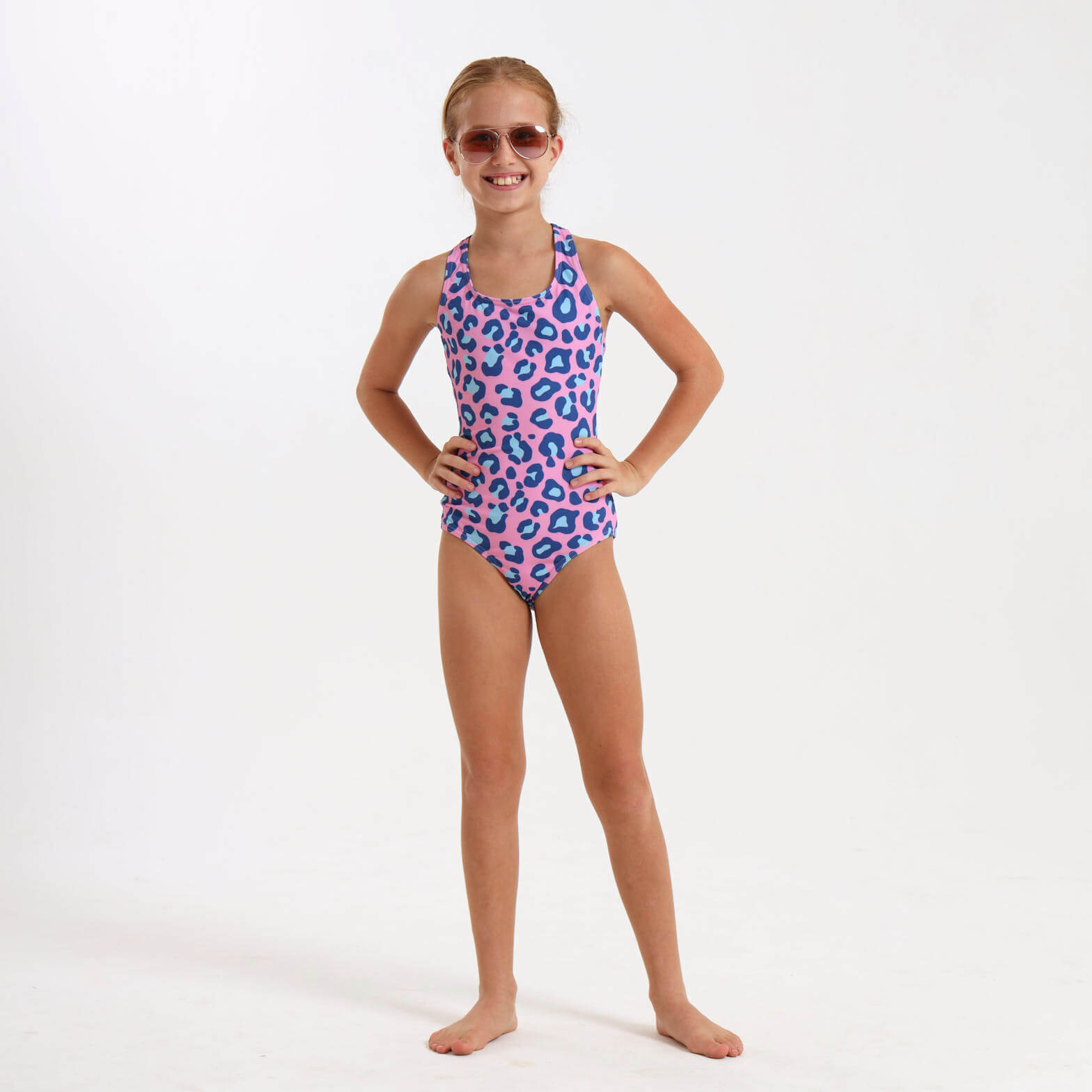 Girl wearing a pink swimming costume with a leopard print pattern