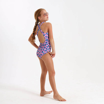 Girl wearing a leopard print swimsuit with a cross over strap on the back.