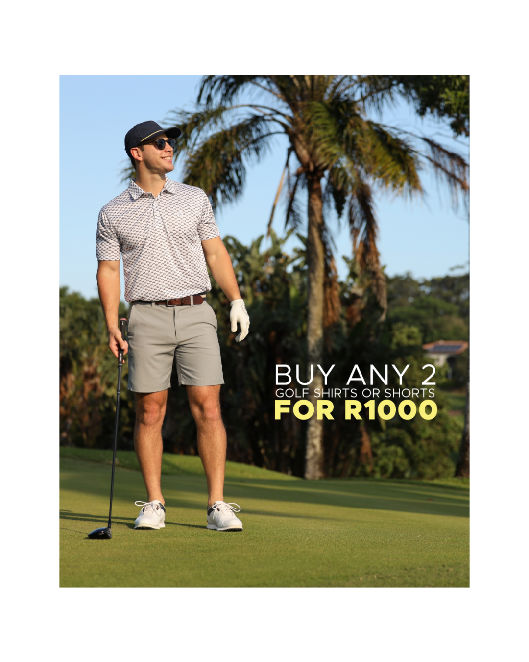 A man on a golf course wearing a patterned short-sleeve golf shirt, khaki shorts, white golf shoes, and a black cap, holding a golf club. Text on the right reads 'BUY ANY 2 GOLF SHIRTS OR SHORTS FOR R1000'.